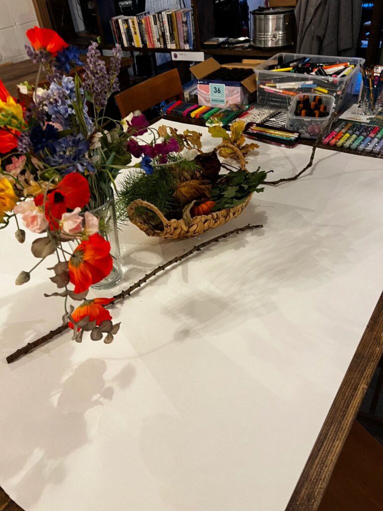 Flowers and art materials laid out for a creative day