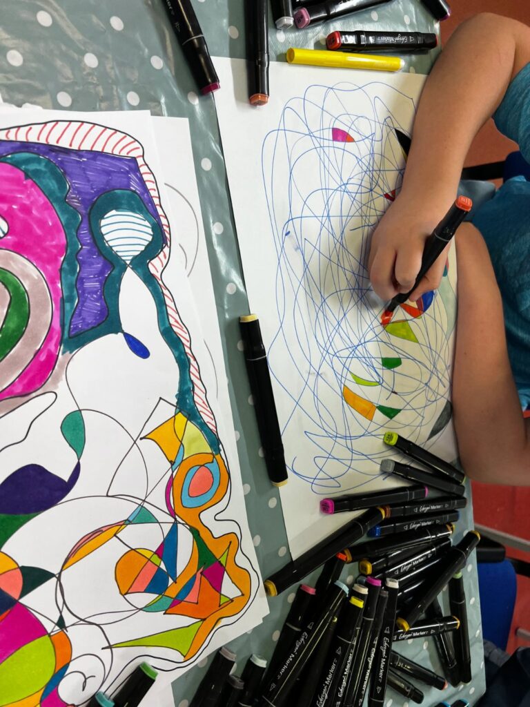 Child drawing patterns with felt tips
