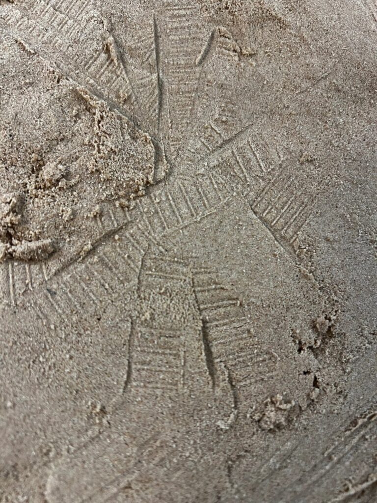 Patterns pressed into sand