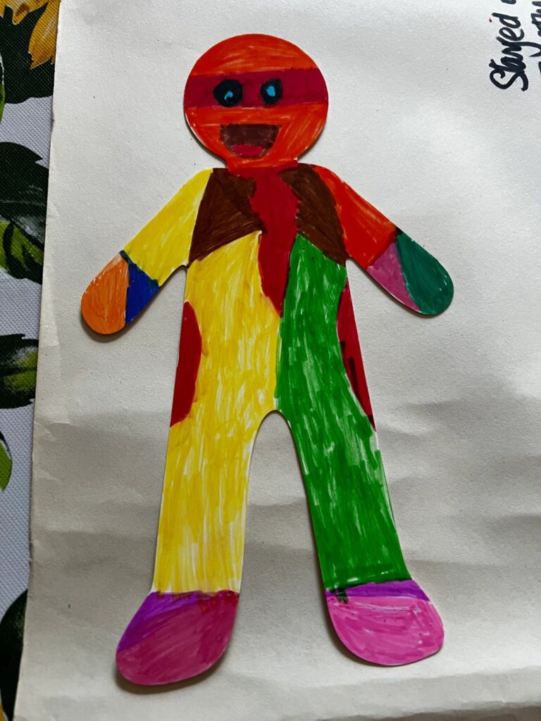 Child's colourful paper figure artwork